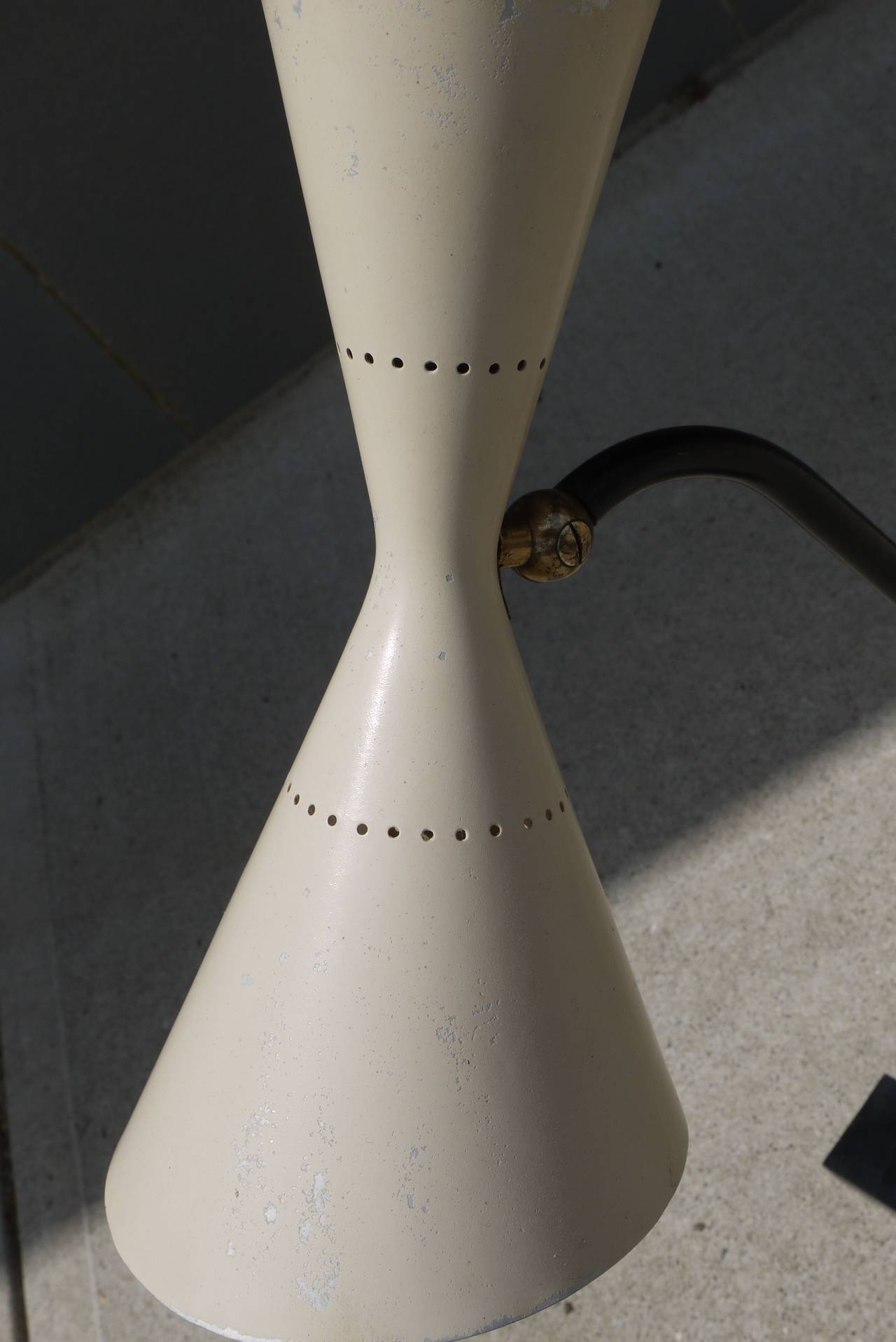 Stunning form on this 1950s modernist Stilnovo desk lamp with a weighted base and adjustable double cone shade. Original sticker still attached to interior of the shade. Lamp has been left as found and has been cleaned and waxed.