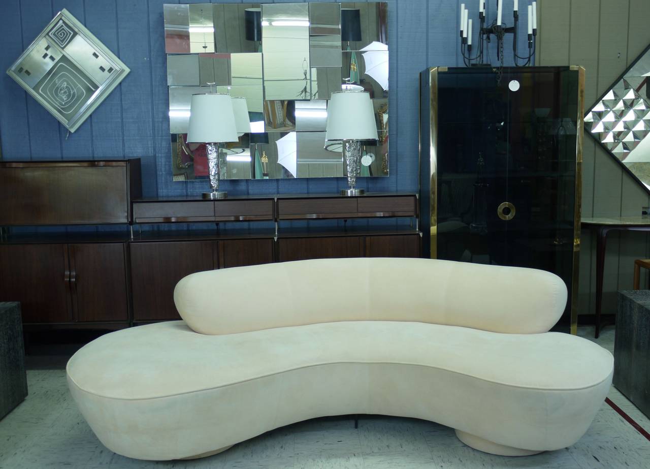 A sculptural sofa designed by Vladimir Kagan in 1950s and made by Directional, USA, circa 1980s. One of Vladimir Kagan's most famous designs which seamlessly blends style and comfort. The serpentine sofa is supported by two upholstered pillars and a