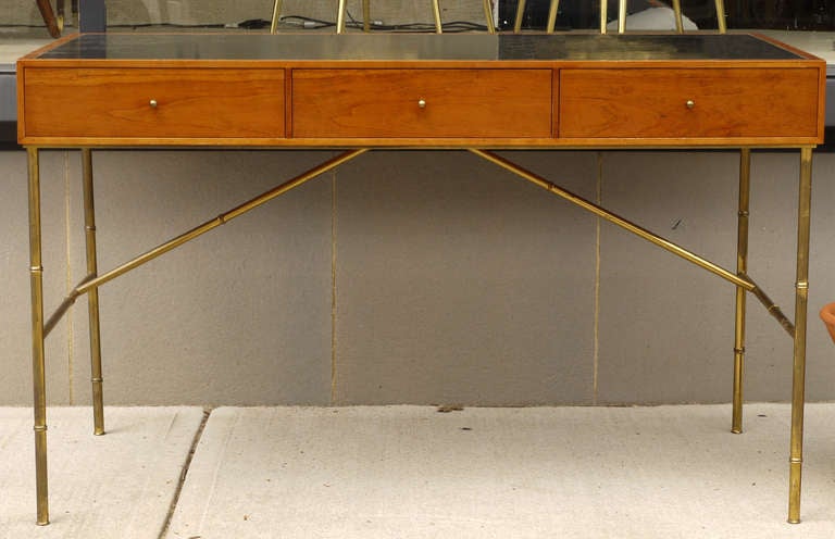 Wonderful and rare desk designed by Kipp Stewart for Directional Furniture and most likely produced by Calvin.  Stunning solid brass faux bamboo legs and pulls, desk is covered in black leather as well as the interior of the drawers.