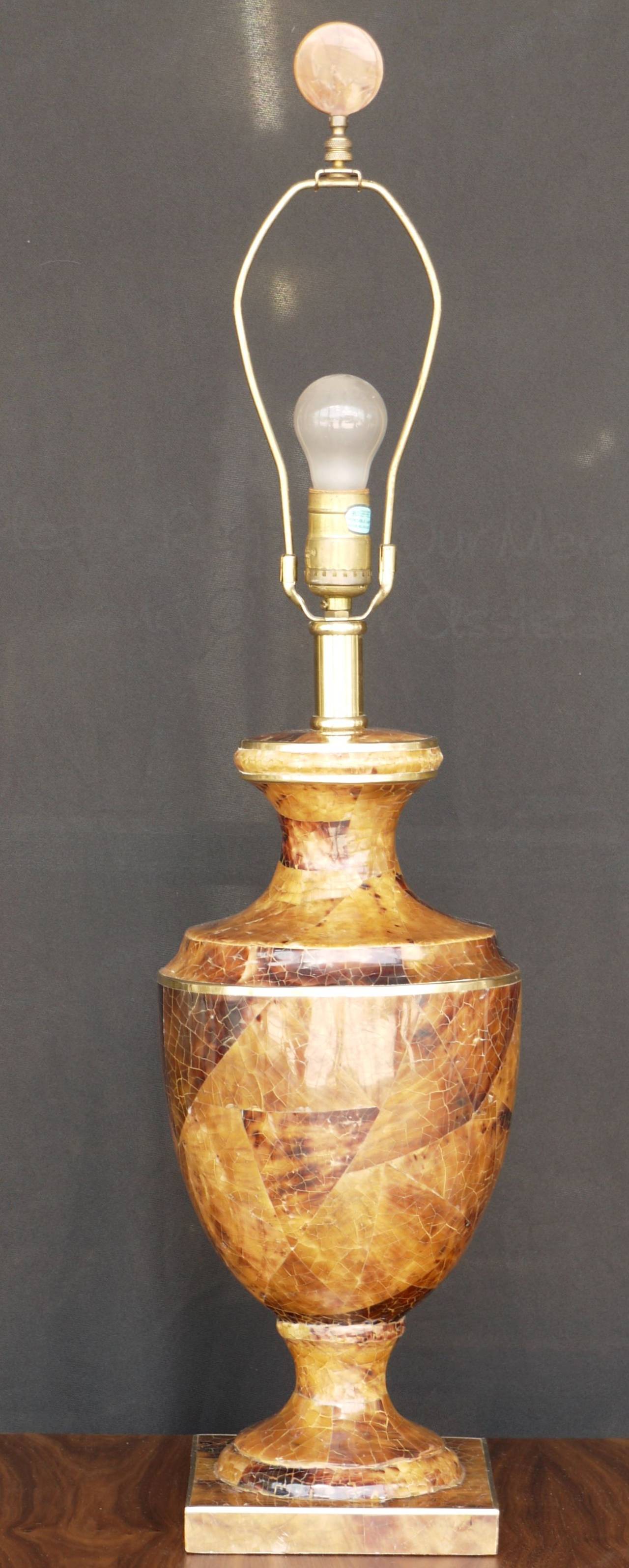 A classical penshell urn shaped table lamp with brass detail. Penshell is a beautiful alternative the tortoise shell and is constructed in a similar manner as eggshell lacquer. The brass banding is pinned in place, and the whole structure is over a