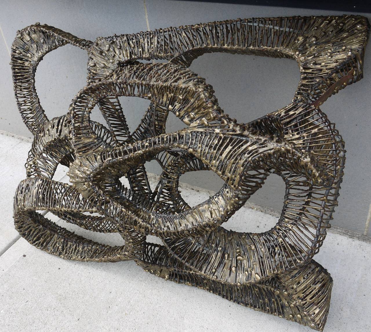 Stunning large Brutalist wall sculpture made of brass melt coated steel and many hundred if not thousands of small pieces of steel. A wonderful three dimensional organic abstraction which would look killer hung and lit from a few different sources