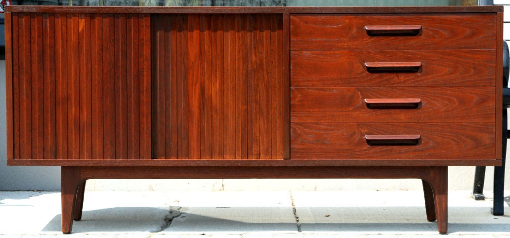 This is a one of a kind Japanese bench made teak sideboard, that blends seamlessly with Danish Modern.  It was purchased in Japan in the late 1950s.  Four dovetailed drawers with solid teak fronts and bookmatched drawer fronts, with cantilevered