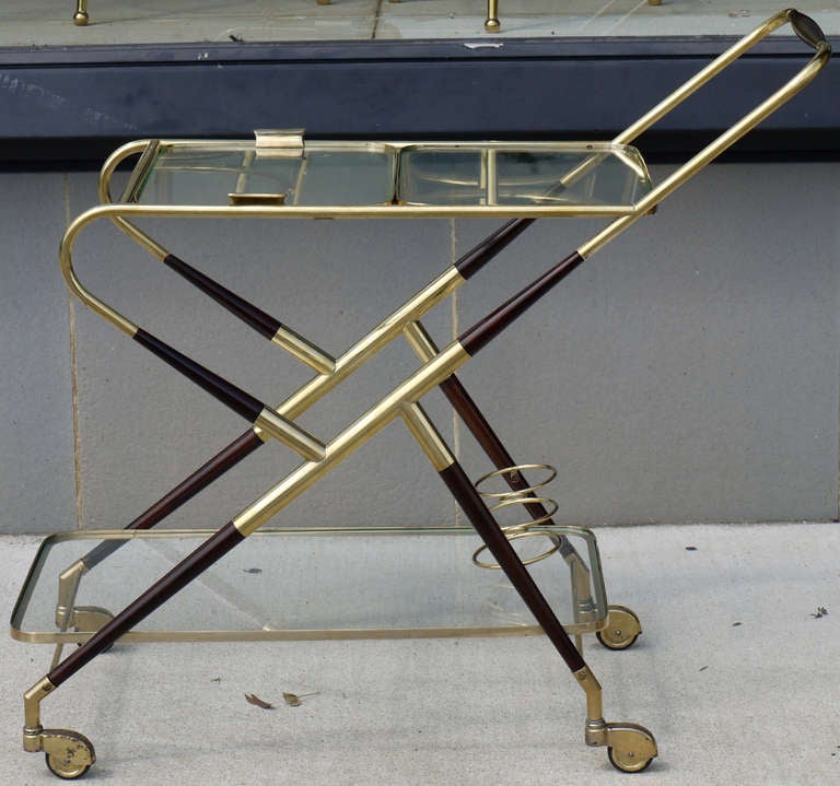 Stylish modernist bar cart by Cesare Lacca in brass and ebonized lacquered ash.    Striking profile and sculptural look, featuring a lower level bottle rest and a removeable tray for delivering cocktails.  Design is often attributed to Fornasetti or