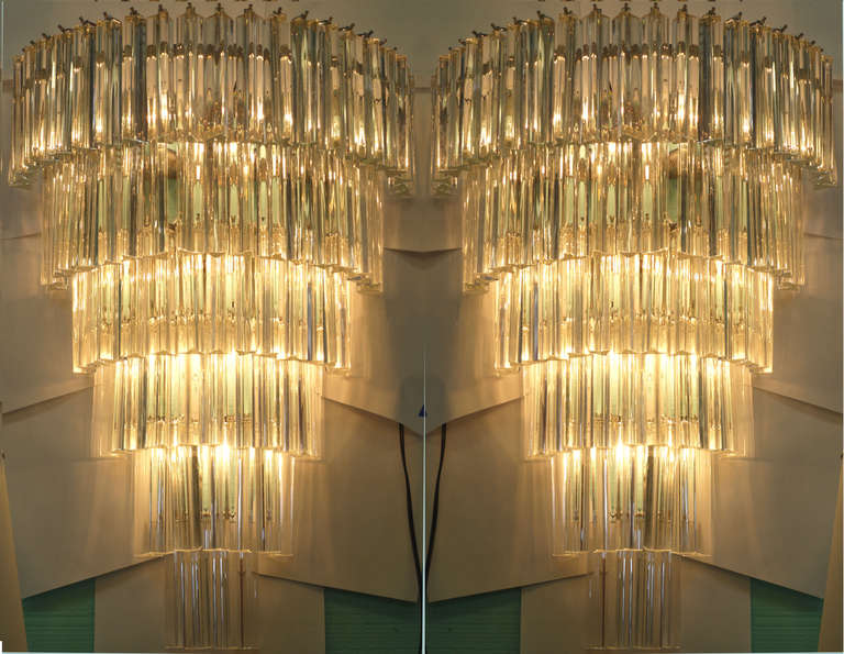 A beautiful large pair of Venini triedi sconces with 78 prisms and 8 chandelier style bulbs.