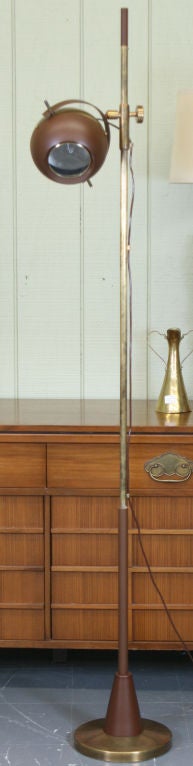 Rare lampadaire réglable conçu en 1955 par Oscar Torlasco pour Lumi. Elle est fabriquée en laiton patiné et émaillé, avec un spot pivotant en forme de globe oculaire et une grande lentille en cristal poli qui diffuse la lumière de la lampe.  La