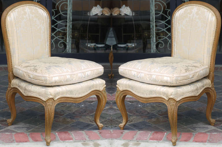These bergeres were produced by Lombardi Gloff and Co. in the mid 1940s.  The quality is higher and lines on these are better than any I can find.  Far nicer than any Jansen piece of the period.  Both featuring original damask upholstery in