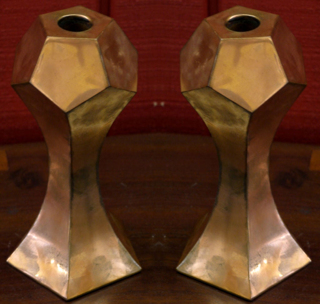 Pair of geometric candlesticks made from thickly forged sheet copper with wonderful patination.  These sculptura; candlesticks are signed and numbered on the bottom.