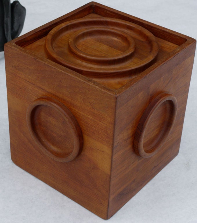 Jens Quistgaard for Dansk solid teak ice bucket circa 1960. Solid teak construction with bullseye design top and circle designs on the side which act as handles showing fine joinery techniques along with fitted plastic waterproof plastic interior. 