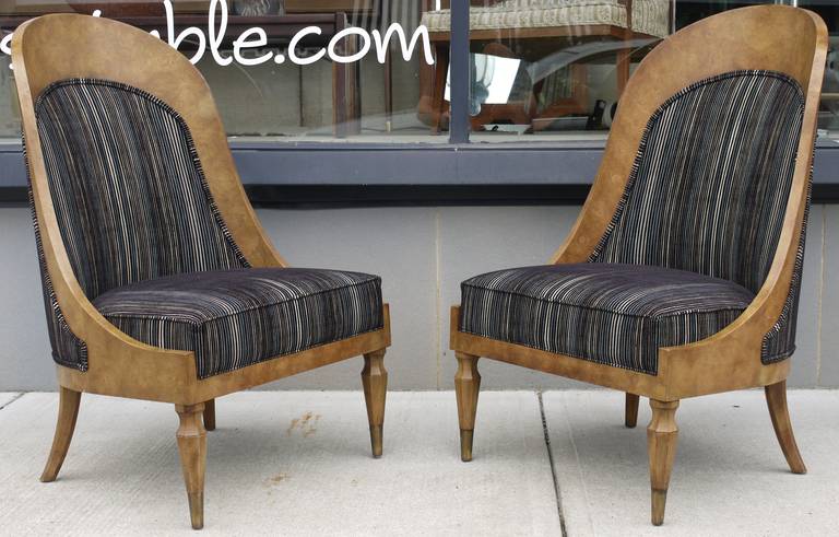 Pair of low spoon back chairs by Mastercraft with a slight biedermeier influnce covered in amboyna burl and finished with brass sabots on the feet.   We had these redone in a striped cut velvet style fabric.