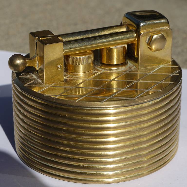 Glamorous table lighter by Swiss watch and jewelry maker Gubelin which was distributed and marketed by Dunhill in the 1960s. Detail on the lighter is remincent of the work of Tommi Parzinger.