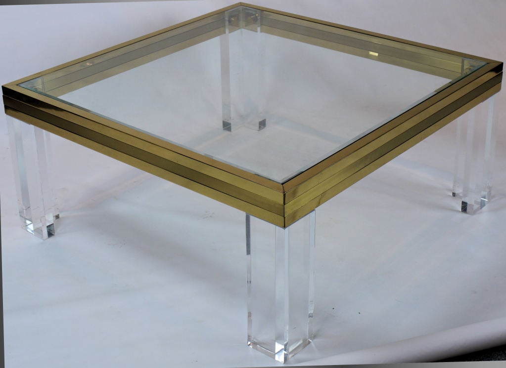 Stylish satin and polished brass coffee table attributed to Romeo Rega.  Constructed of heavy solid brass tubing with super tight construction.
