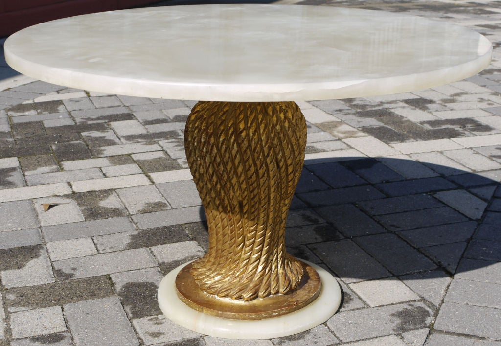 Vintage Italian gilt wood table with an white onyx top and it rests on an onyx plinth.