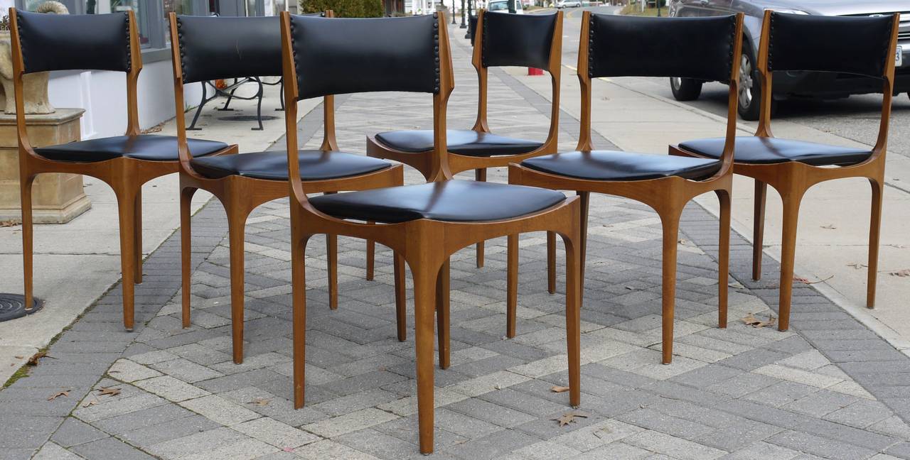 A wonderful vintage 1950s set Italian walnut and leather dining chairs with a great sculptural shape.