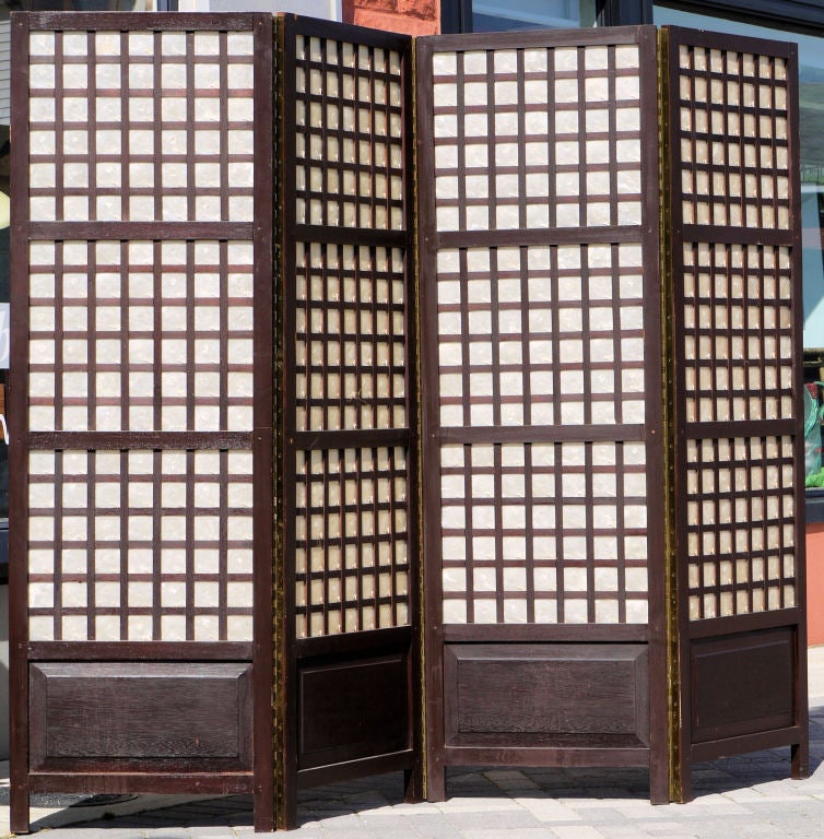 Vintage Teak and Capiz Folding Screen with a great architectural look, the teak frame is constructed using mortised and tenons and pegs, and each capiz shell is held in place in the fretwork.  The hinges on the screen are a heavy solid brass piano