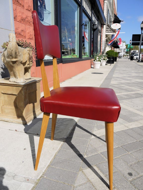 Stunning set of 8 Italian dining chairs with dramatic angles and nice details. Similar style to the Ico Parisi bow tie style backs but with a more modern angular edge.