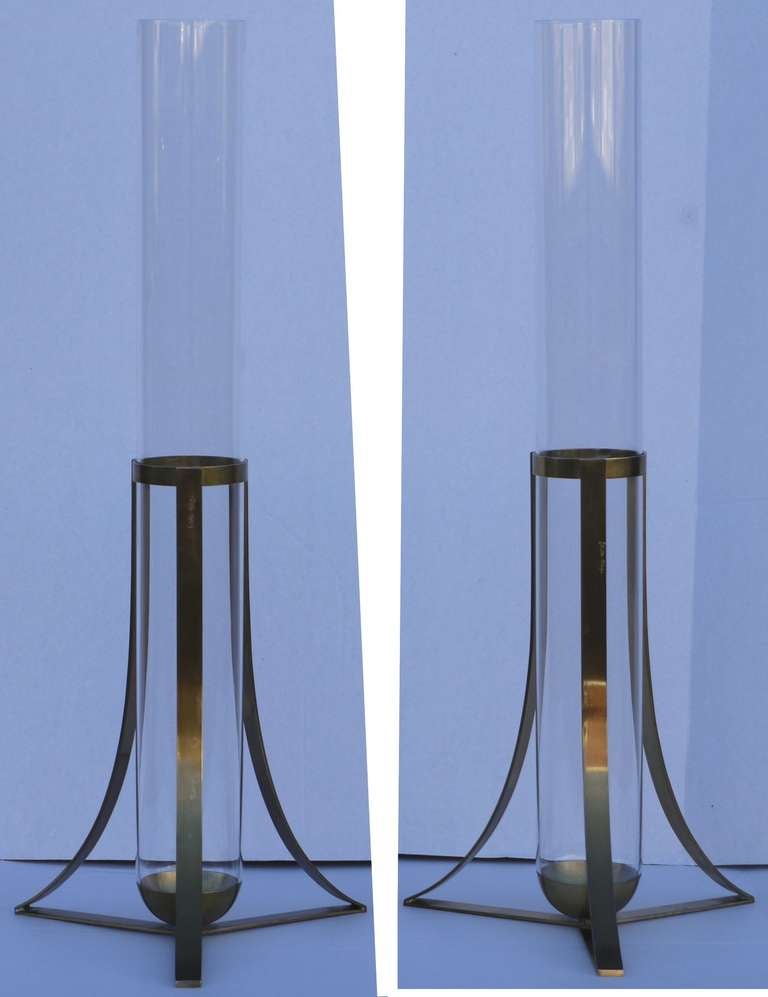Pair of large signed brass and glass vases by designer Gabriella Crespi.     Featuring three buttress legs which support a glass test tube like base.