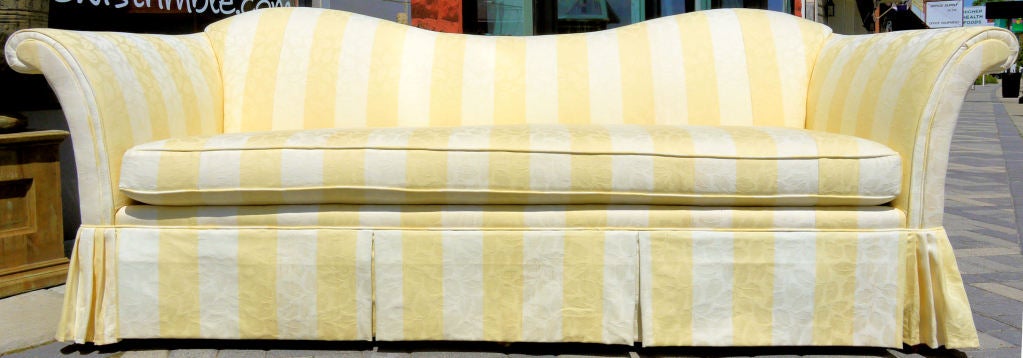 Stunning almost surreal sofa with scroll arms and a reverse camel back in the style of Dorothy Draper.  Vintage striped upholstery.