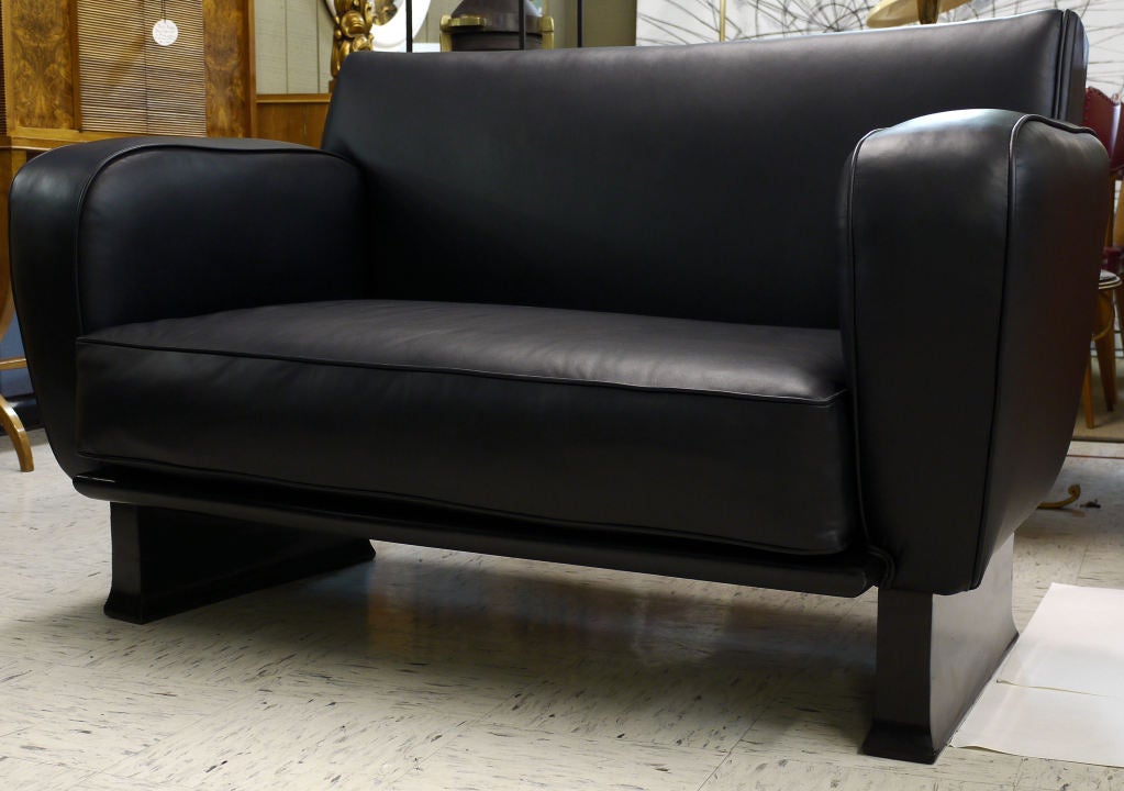 Black Leather Love Seat by Vittorio Valabrega on stylized black lacquer legs.  Stunning Shape and nice architectural plinth base.  Provenance available on request.