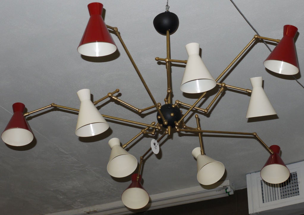 Stunning 10 Arm Adjustable ceiling light which can be adjusted in a large amount of positions.  Lights can put up, down and out or even back in.  Hand machined parts and made from polished brass which has been left to age gracefully.