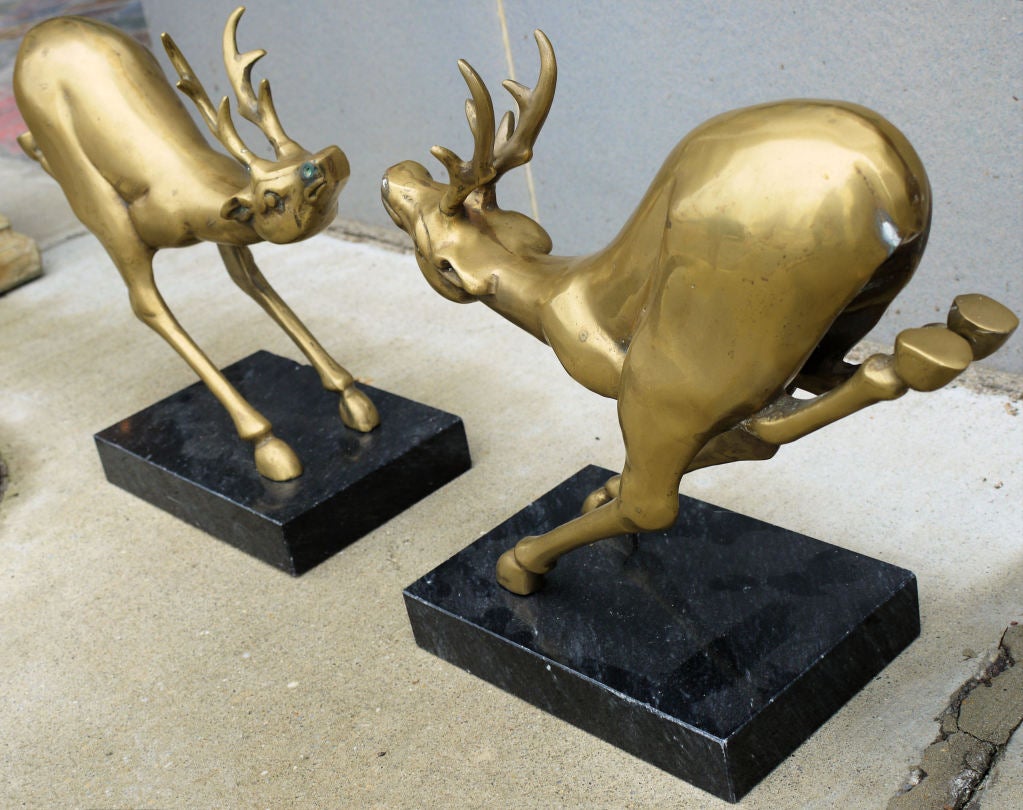 Stunning large brass and leaping deer sculptures circa 1970.  Nicely cast and interesting as a pair leaping toward each other.