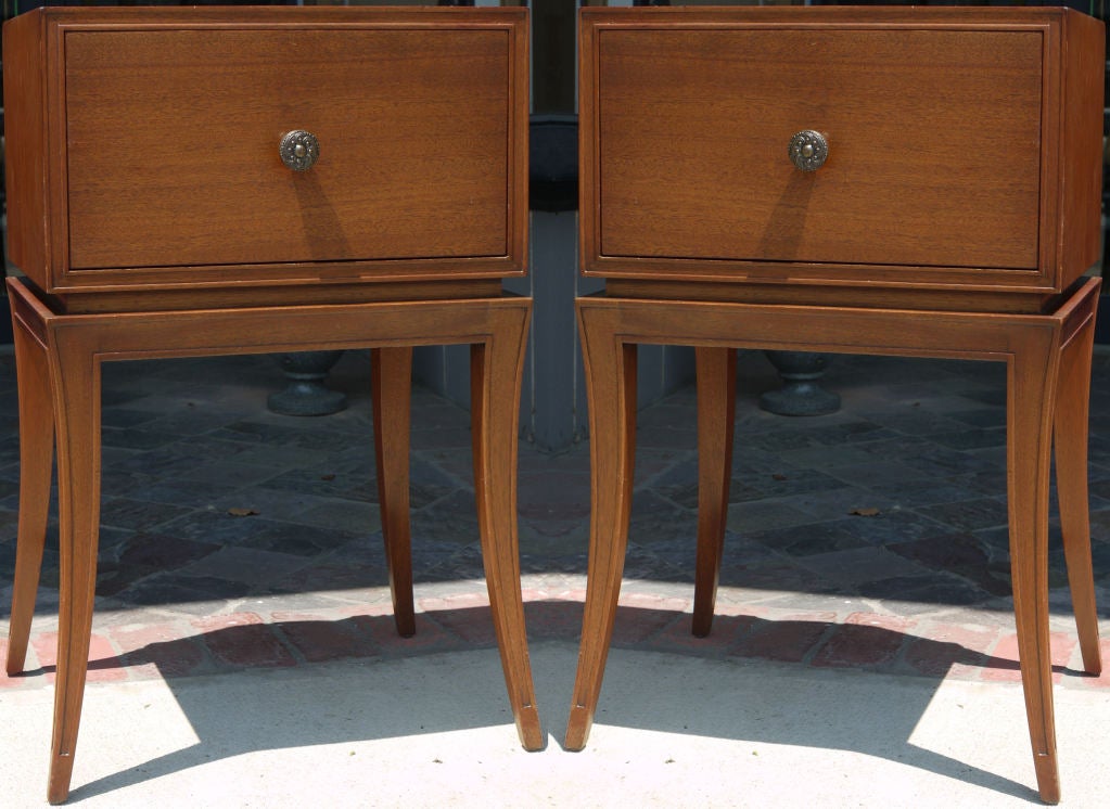 A pair of mahogany end tables or night stands with a small drop front cabinet supported by klismos legs by the Orsenigo Company of NY. I've read that Tommi Parzinger designed for them in the 1950s but I've never found any actual proof.