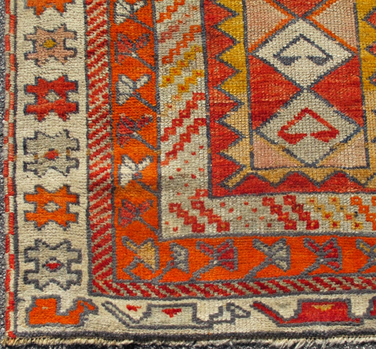 This lovely Turkish Oushak displays a unique design with repeating diamond medallions. The colors are blue, red, orange, ivory, yellow, salmon, green and gold. The border features a repeating key motif. 
4'3 x 12'2.
    