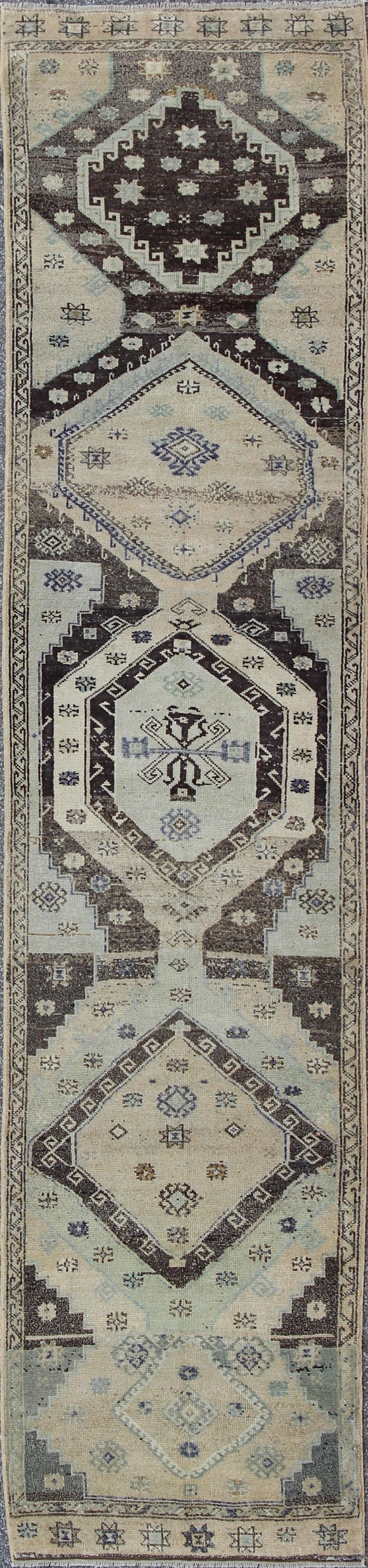 This stunning Turkish Oushak Runner displays a large-scale and highly geometric design. Set on blue, gray, green, dark brown and light taupe, the bold and geometric design is outstanding. 
Measures: 3' x 12'11.