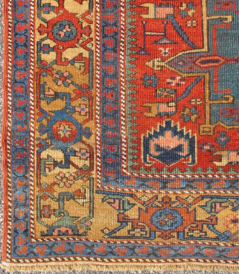Traditionally inspired by the Caucasian designs found in carpets from Russia and northern Persia, this antique Serapi-Karajeh rugs incorporates a distinctive tribal flavor. Indigo, red, and ivory hues are characteristic features of these tribal