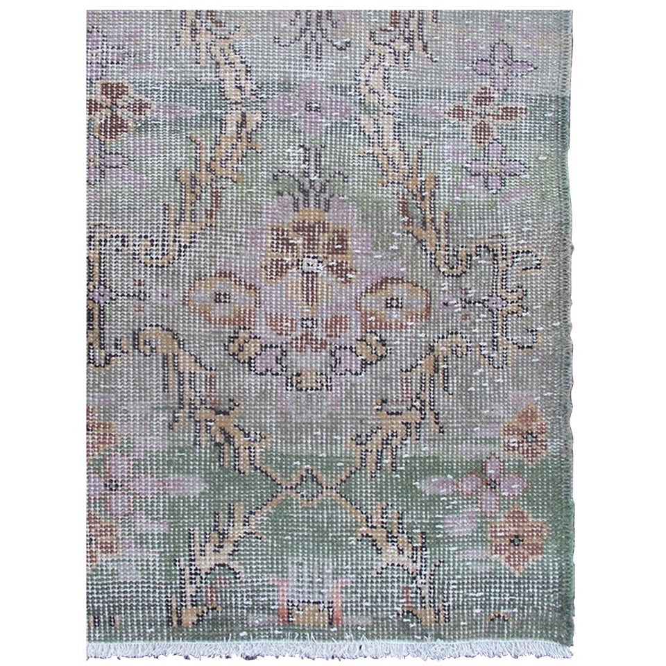 Distressed Turkish Rug with Mid-Century Modern Design.
Rendered on a muted background with a floral pattern and speckled assortment of taupe, light blue, muted green, pink, camel and gray, this Mid-Century rug has an abstract feel in design.