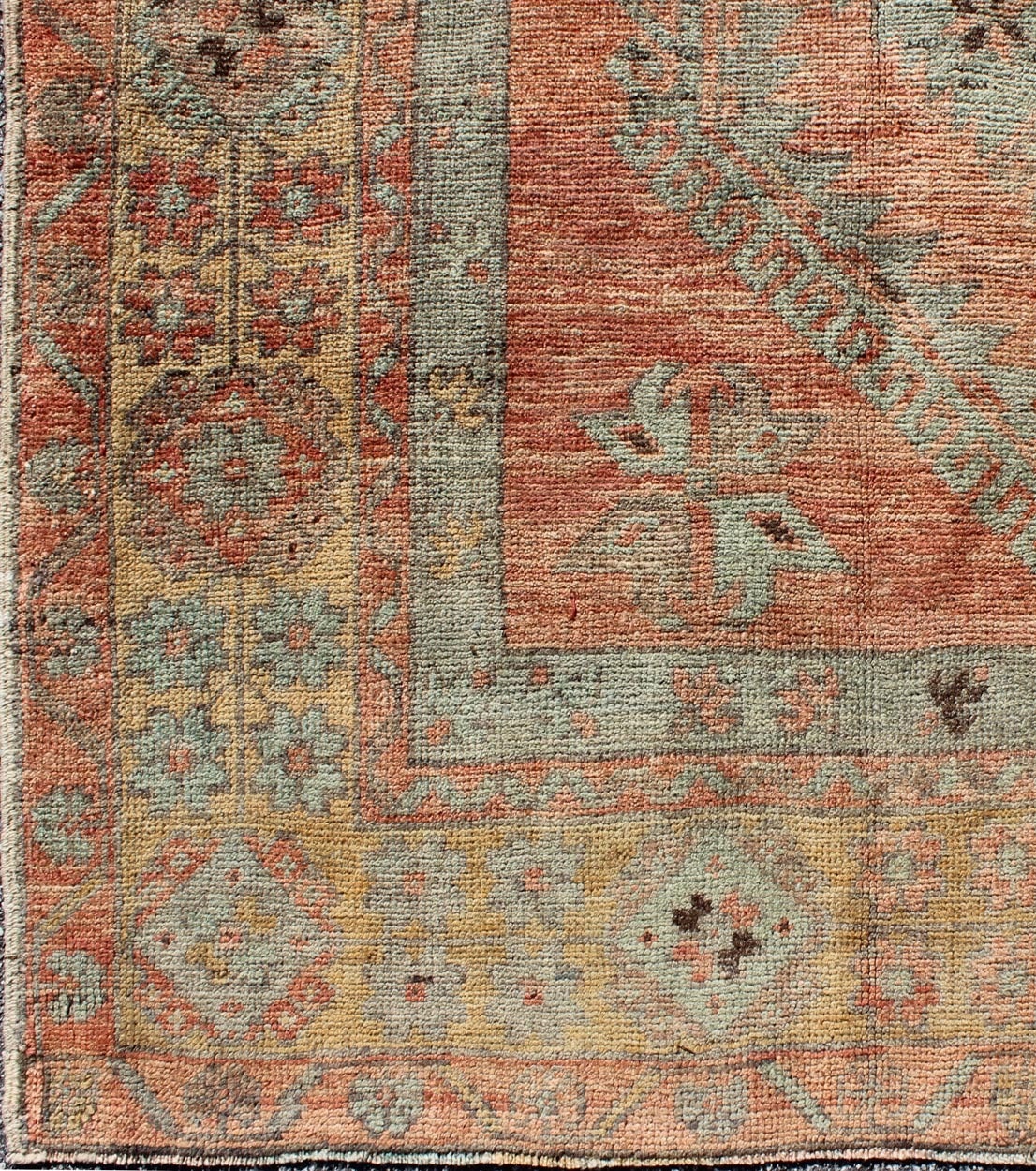 This Oushak gallery runner contains subtle tones of coral, taupe, beige, soft gold, light teal and green, which are highlighted by chocolate and mocha colors. The stylized center medallions accentuate a botanic theme and are surrounded by muted