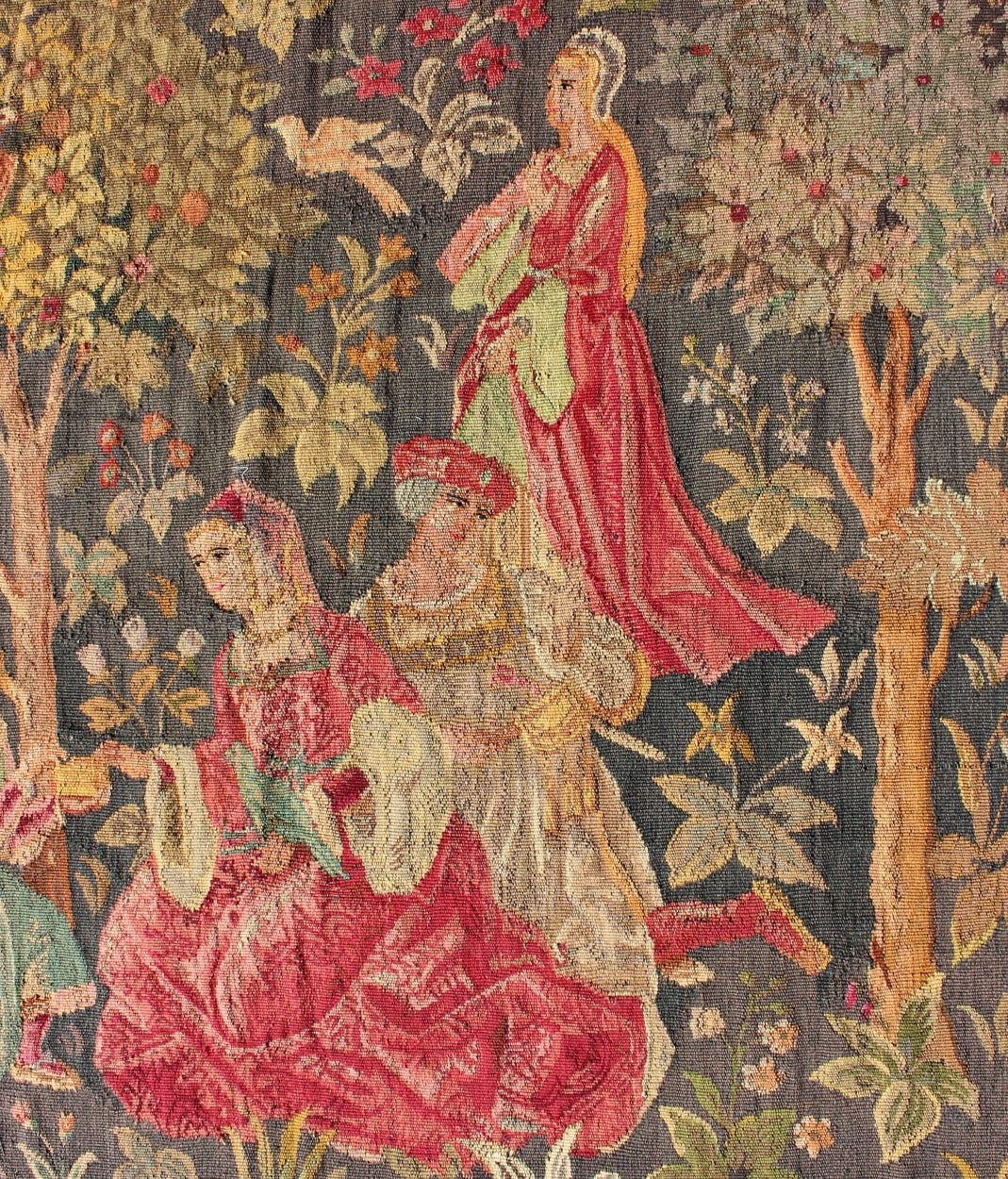 Measures: 4'11 x 7'5.
This Beautiful Scenery design antique French tapestry from the early 1900's features vibrant colors which work off of a medium gray background, depicting a romantic scene amid an orchard.

Antique French tapestry in gray