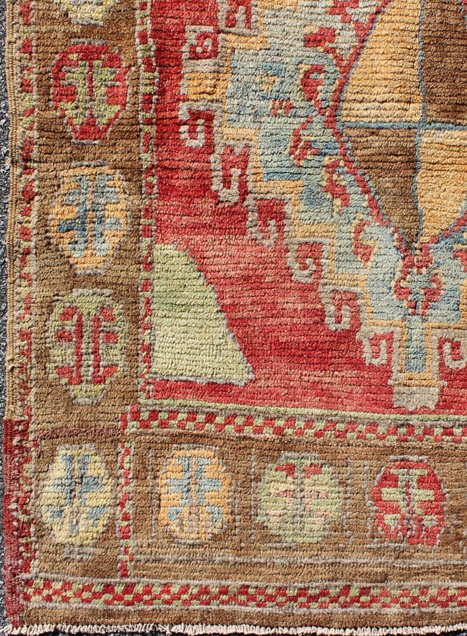 This antique Oushak rug is resplendent with many eye-catching and breath-taking elements of design. Steeped in Anatolian history, this richly symbolic antique Oushak Turkish rug features a quintessential compilation of traditional protection