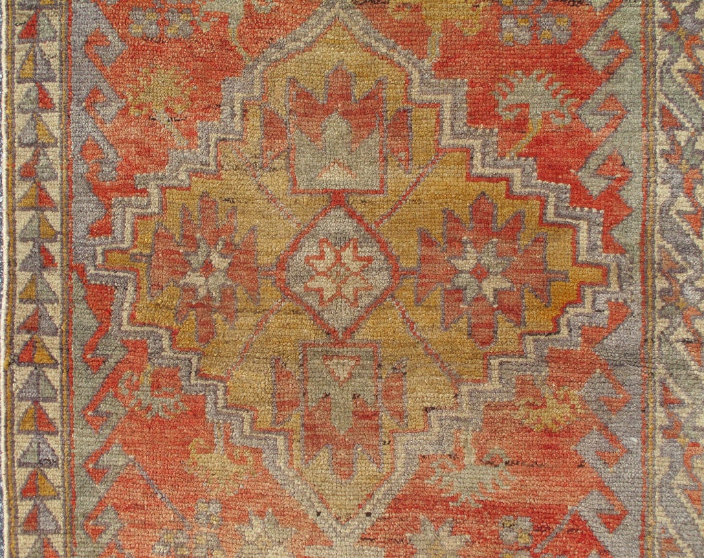 This Antique Oushak Runner from the turn of the early 20 century bears a rich array of delightful colors in an all over geometric design.  2'10 x 9'10