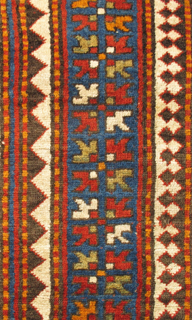 The Sewan Kazak is among the most iconic Caucasian village weaving. This strikingly beautiful antique Kazak displays an incredible array of articulate and bold colors. The bold contours of the top and bottom sectors of the central medallion