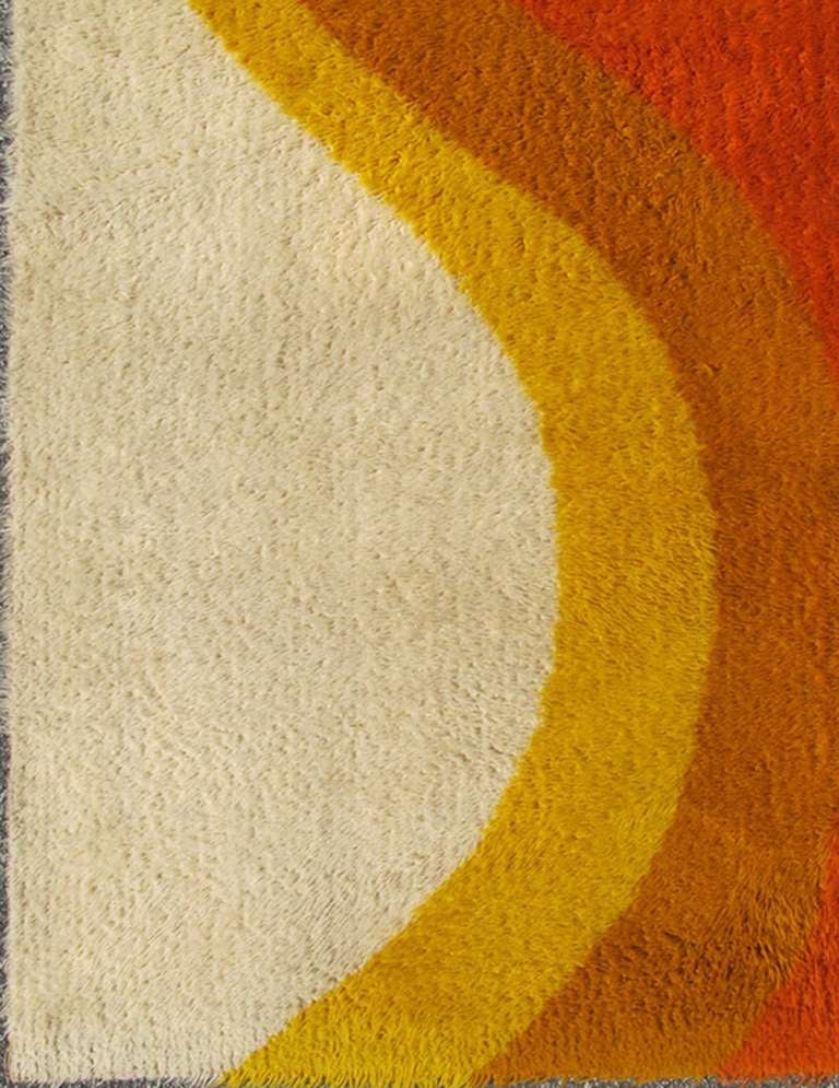 Scandinavian Rya Rug with Colorful Mid-Century Modern Design.
Rya carpets are traditional Scandinavian wool rugs with long pile.  This particular piece features a Mid-Century Modern design with vibrant colors, including ivory, gold, light brown,