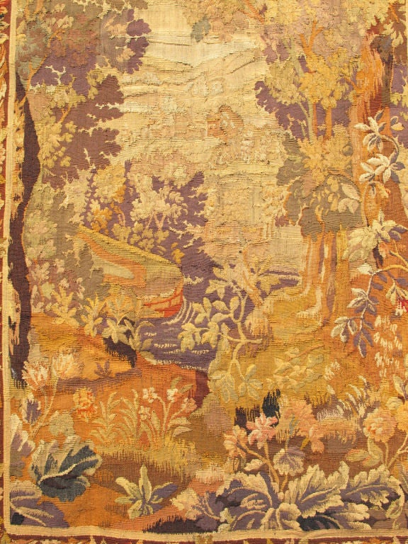 Measures: 4'7 x 7'1.
This enchanting antique tapestry beautifully illustrates the remarkable sense of depth and richness that was perfected by French artisans of the 19th Century. A remarkable display of abundant vegetation and a multiplicity of
