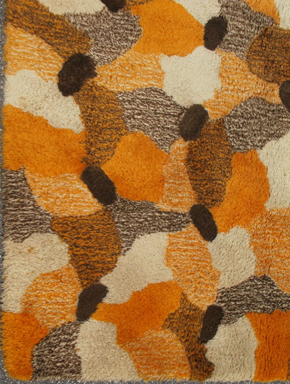 This impressive Mid-Century Modern carpet has lustrous wool and was made with high-and low-technique. With a bold pattern and exuberant colors, this vintage hand-tufted rug was custom-made for a modern setting. 
Measures:           9' x 10'
List