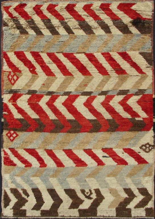 This vivid Turkish Tulu has bright red, blue, yellow, chocolate brown and ivory colors. The stripe pattern repeats in the rug. with extremely fine wool the texture of this rug is soft and feel good to touch.