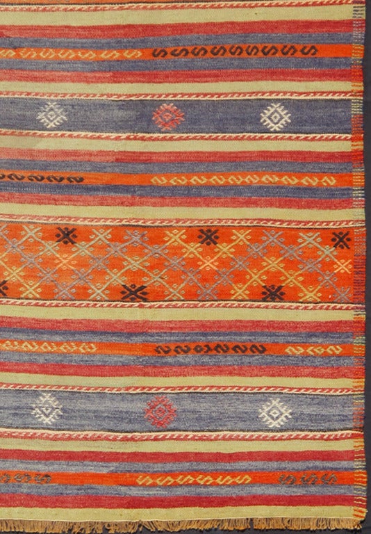 This Turkish Kilim features a striped design and partial Jajeem embroideries. The combination of gray-blue and orange stands out. Other accent colors include brown, ivory, yellow, blue and red. Measures: 6.1 x 11.4.
List price $3,000.00.
Reduced