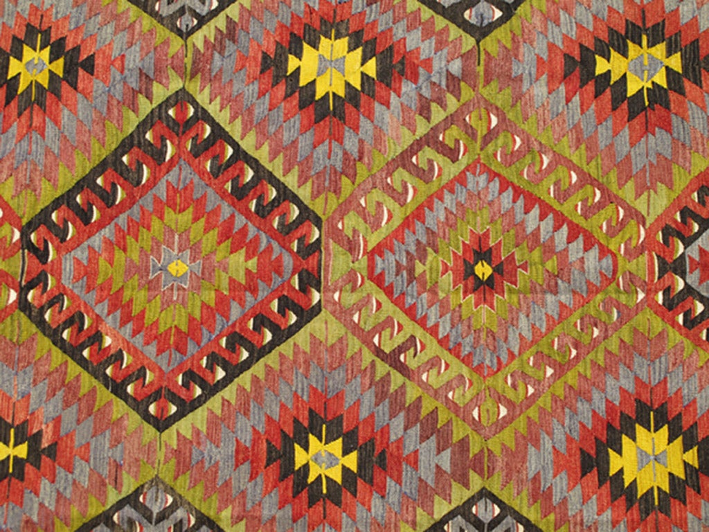 Measures: 5'8 x 8'11.
This colorful Turkish Kilim boasts a repeating diamond pattern in vivid greens, yellows and reds, giving it a very modern look, perfect for modern and casual interiors. 

Vintage Turkish Kilim with colorful diamond design,