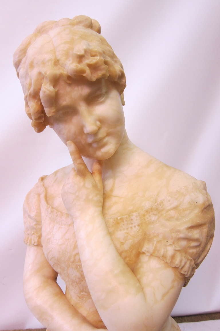 An alabaster bust of a perplexed young lady holding a note, inscribed in Italian translated, 