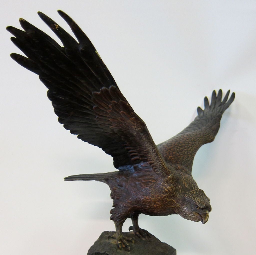This is an exceptionally detailed Bergman bronze of a powerful eagle with wings expanded. A cold painted bronze, this extraordinary bird, perched upon a tall green-veined marble plateau makes a dramatic statement. Clearly, the artist took great