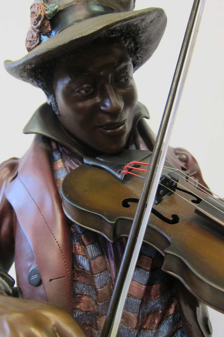 Inspired by French artist Louis Hottet (1834-1905), A M Matthews sculpted a series of bronze busts of black musicians. This 20th century detailed bronze sculpture of a stylish fiddle player is artist, A M Matthews, signed. The bronze is vividly