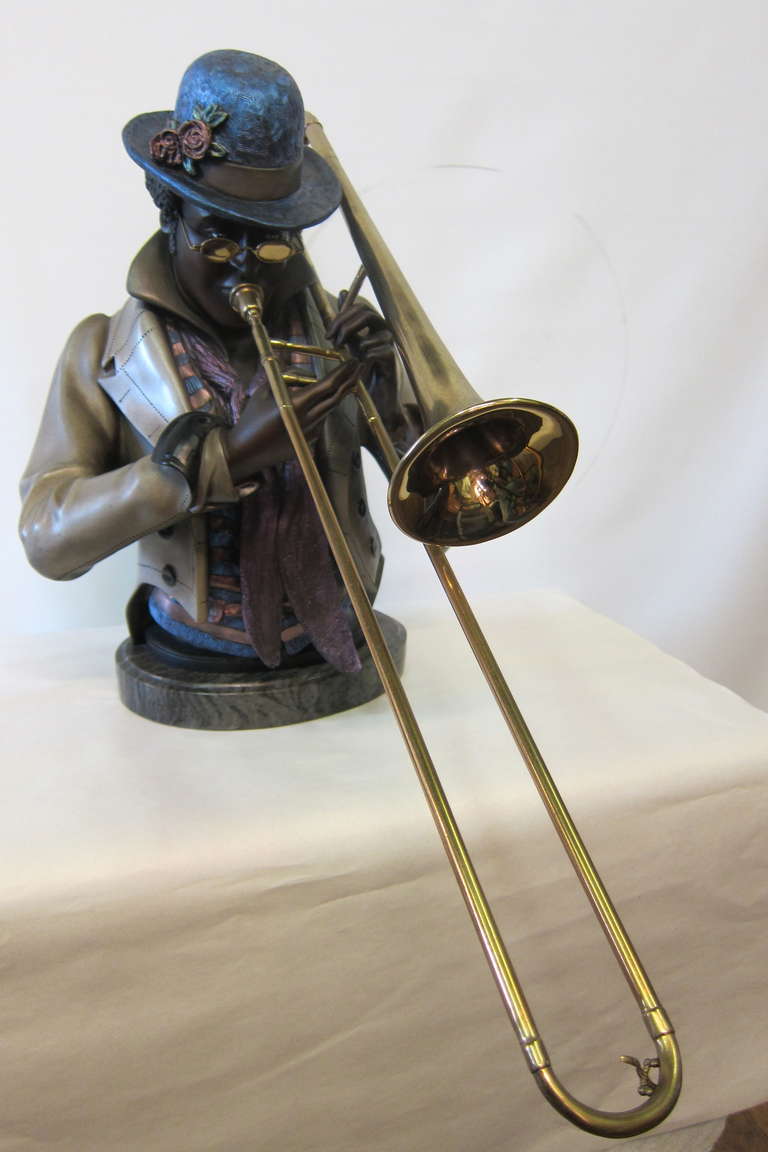 Inspired by French artist, Louis Hottot (1834-1905) A M Matthews produced a series of bronze busts of black musicians. This 20th century bronze features a beautifully detailed rendering of a New Orleans black Jazz trombonist playing  his horn.