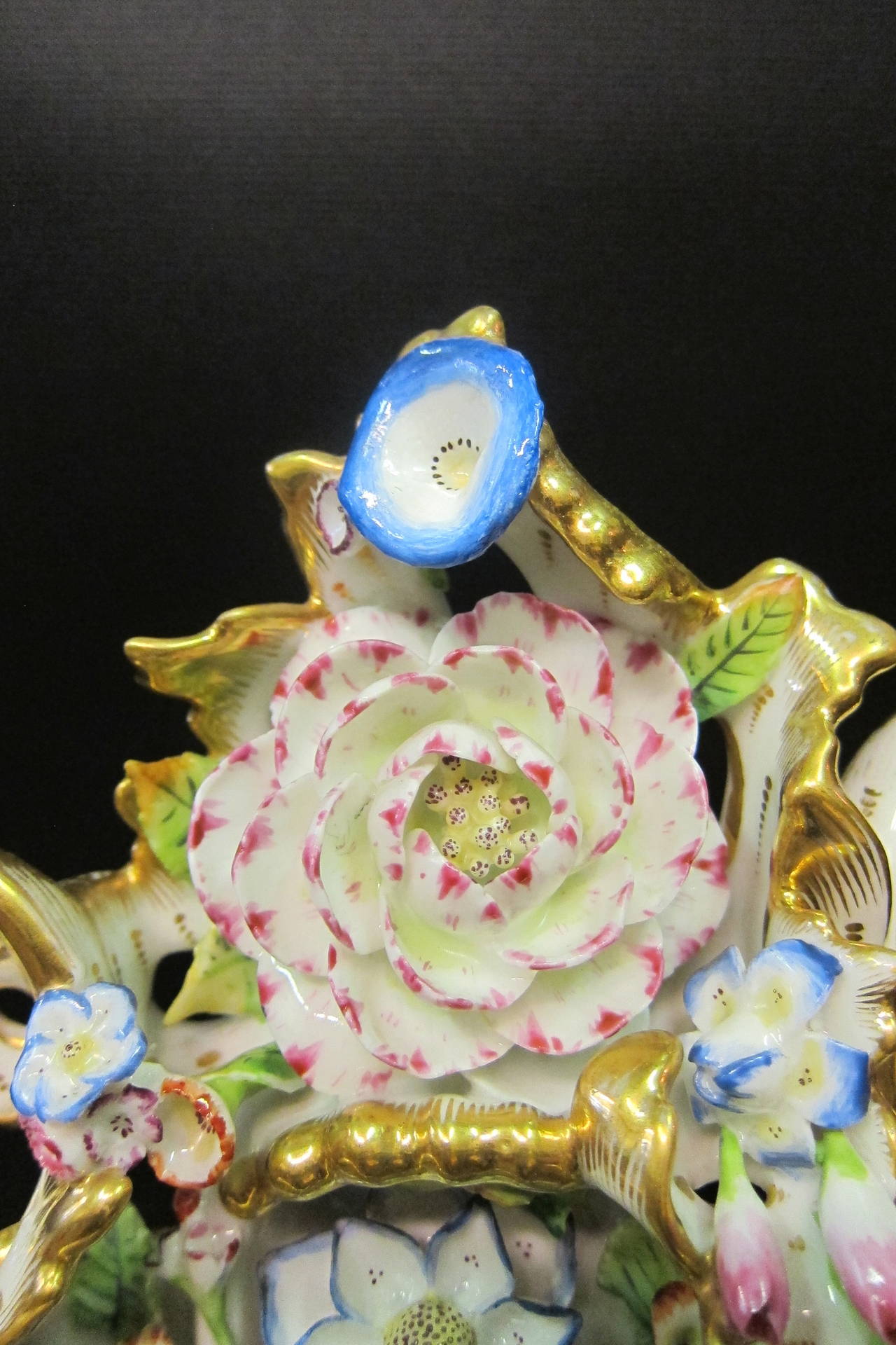 This exceptional Paris Porcelain clock with it's original fitted matching plinth is a rare find. Circa mid 1800's, this elaborately designed mantle clock is detailed with hand applied & hand colored floral accents that nestle within the spiraling