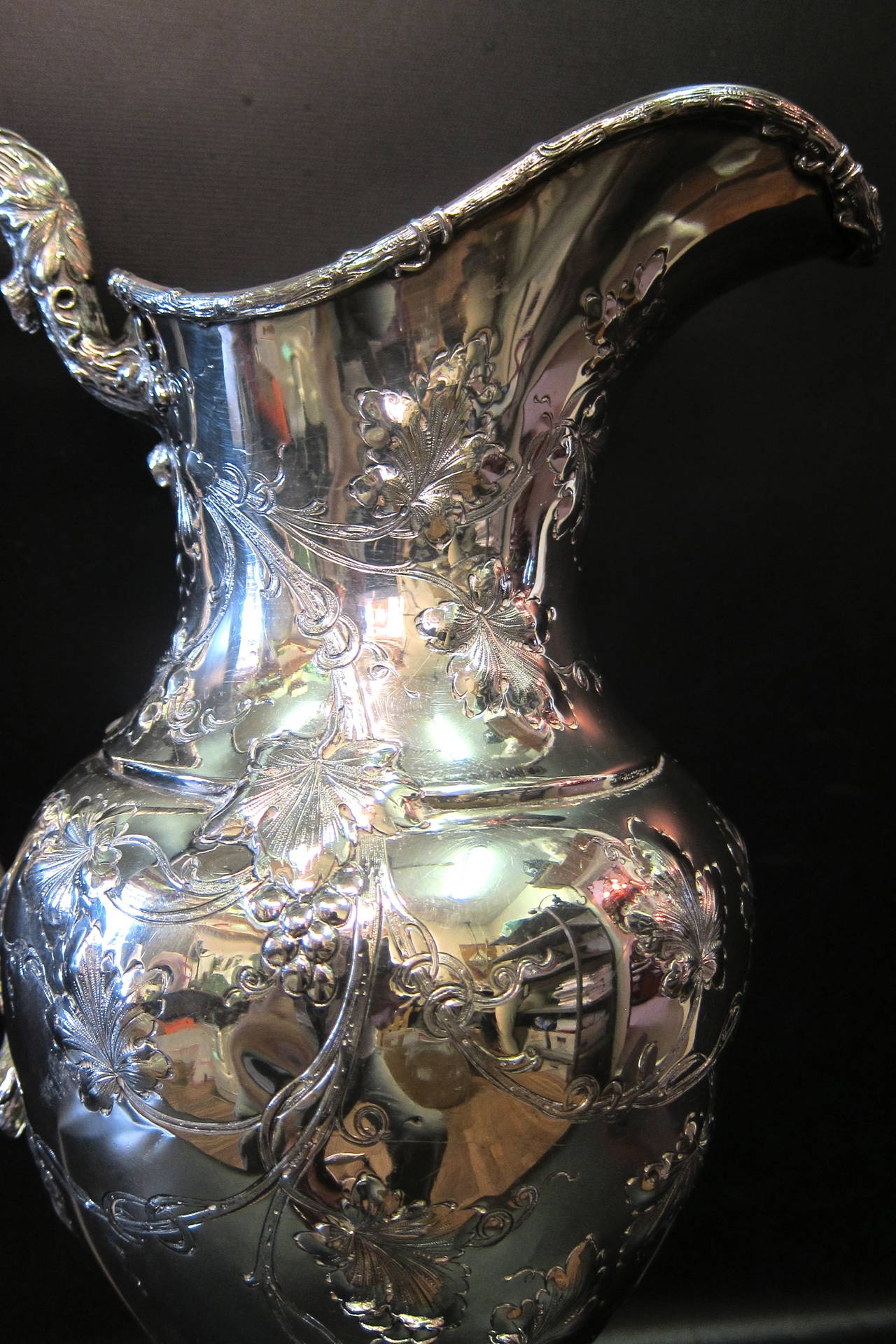 These images represent an example of the quality & beauty of the sterling silver distributed by Tiffany & Co. near the end of the 19th century. This extraordinary wine pitcher is 50 troy ounces sterling & is decorated with a detailed grapevine