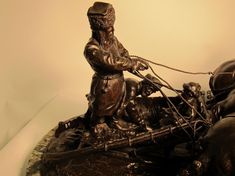 This vintage 19th Century Russian Bronze depicts a winter scene with two Cossack men & a child in a sled driven by three magnificent horses.
Every aspect of this sculpture is highly detailed & skillfully rendered.
The bronze has a rich dark