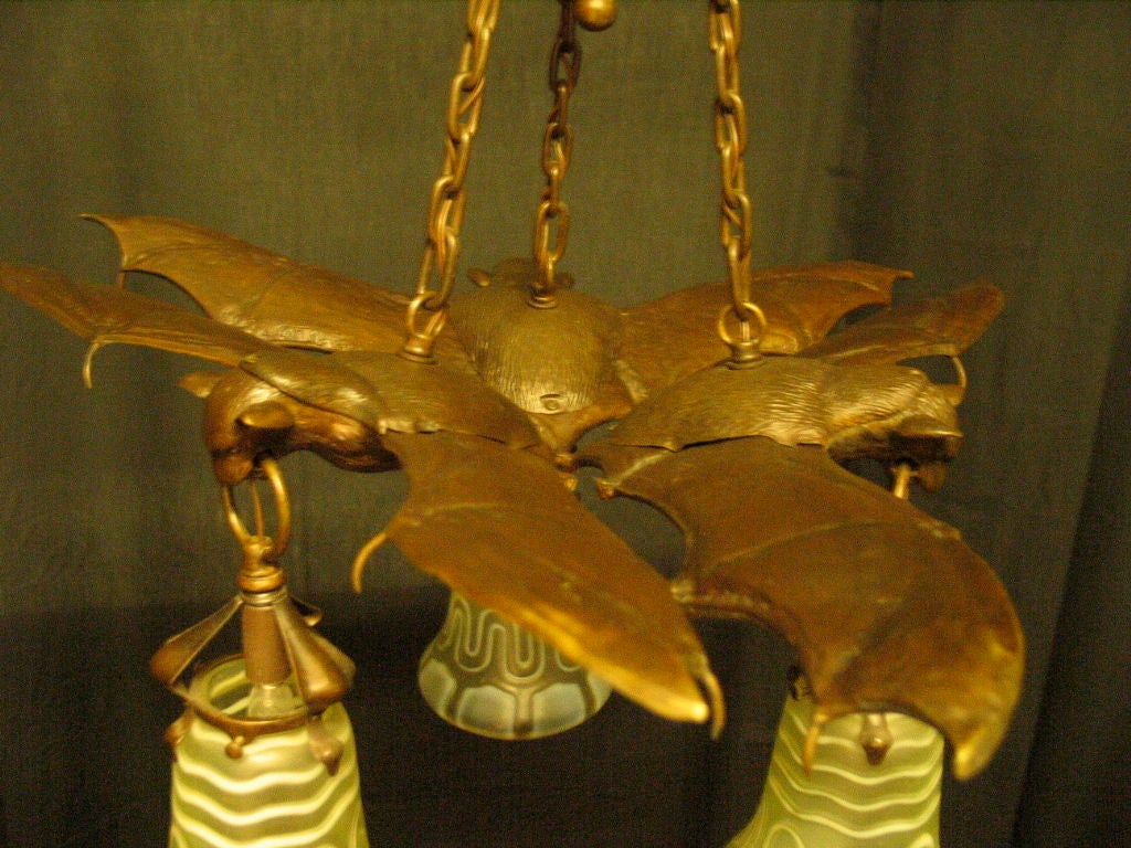 A vintage fantasy fixture with three well defined flying bats. Each displaying fully extended wings and menacing eyes. This unusual bronze Austrian fixture, circa 1910, has a warm, dark brown patina that enhances every detail. This stunning light