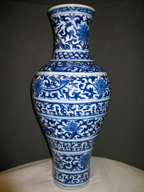 A charming oriental Chinese oversized floor vase is decorated with vivid deep blue<br />
multiple bands of authentic Asian motifs against a soft white background. There are ten banded patterned scrolls enhancing the grandeur of this significant