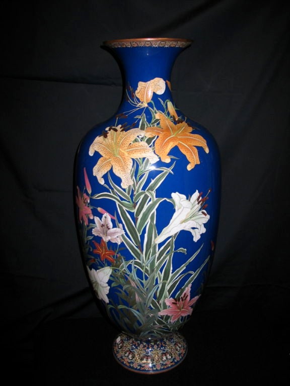 Magnificent Japanese cloissone from the late 19th century. This huge, unique Japanese cloissone' oviform enamel vase, decorated with beautiful blooming tiger lilies in vivid colors against a dark blue ground. This vase enameling, in the art nouveau